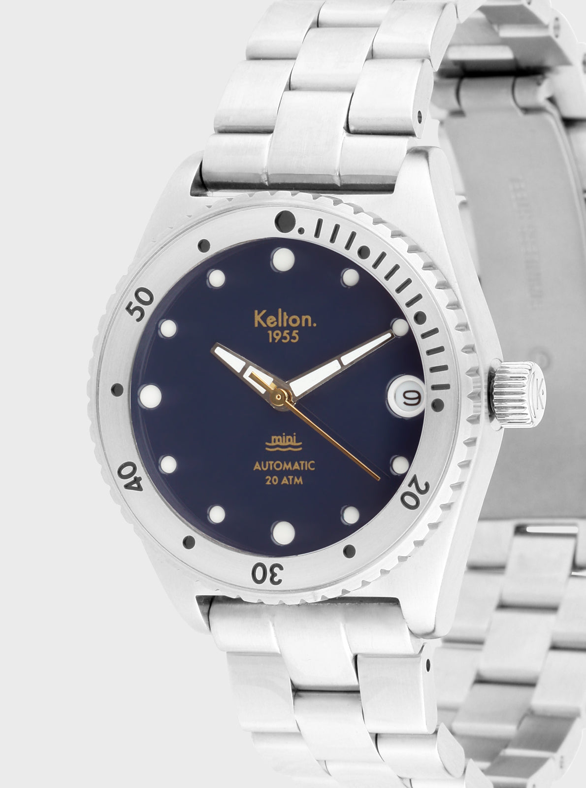 Image of Montre de plongée Mini : cadran bleu marine et aiguilles dorées, lunette crantée.